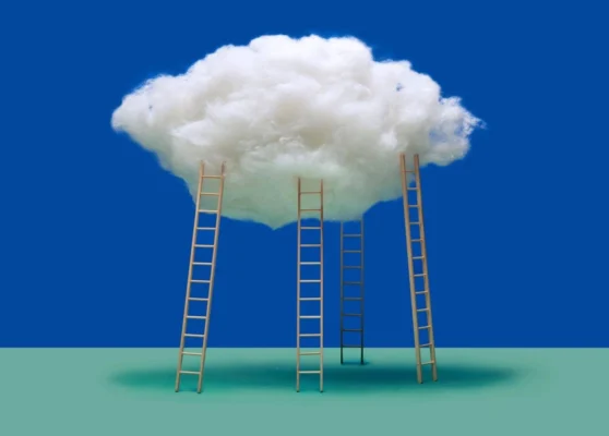 An artistic image of four wooden ladders ascending towards a single, large white cloud against a solid blue sky.